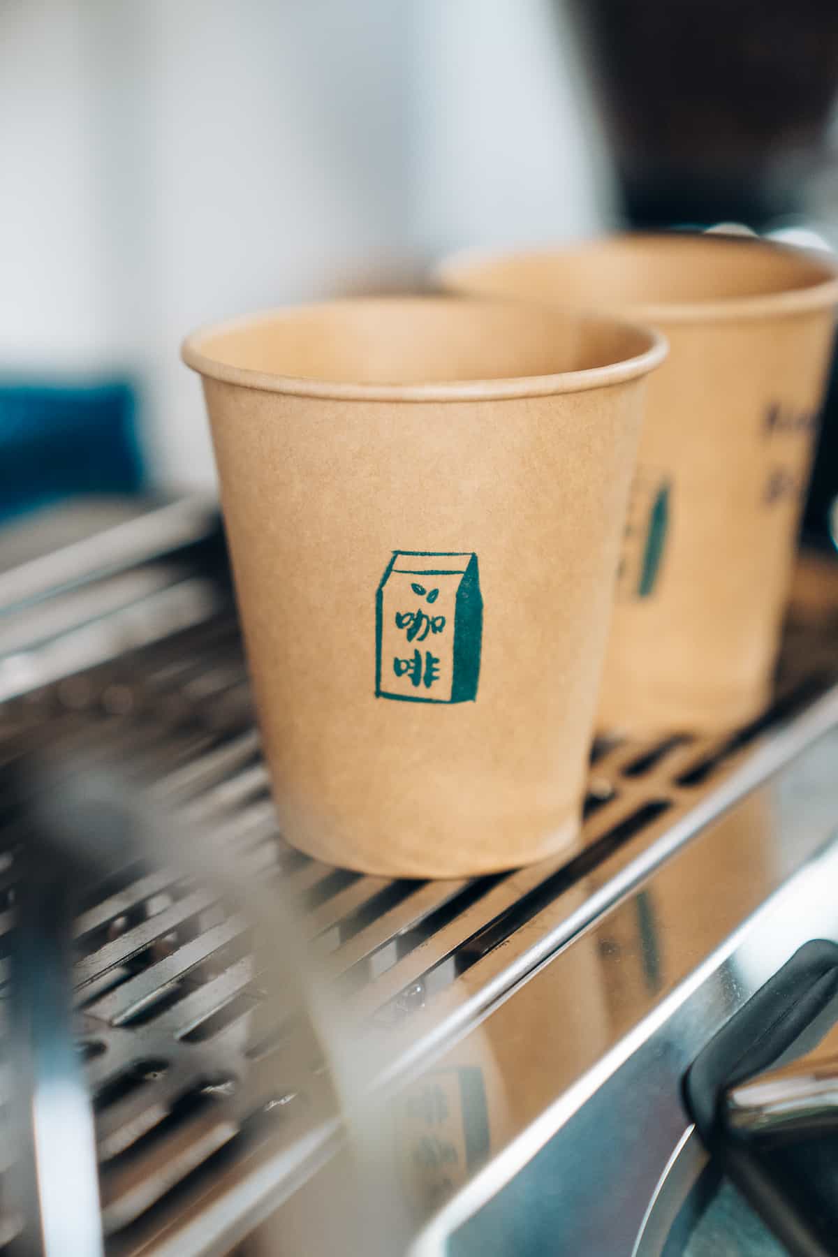 Blue house coffee branded cups on espresso machine